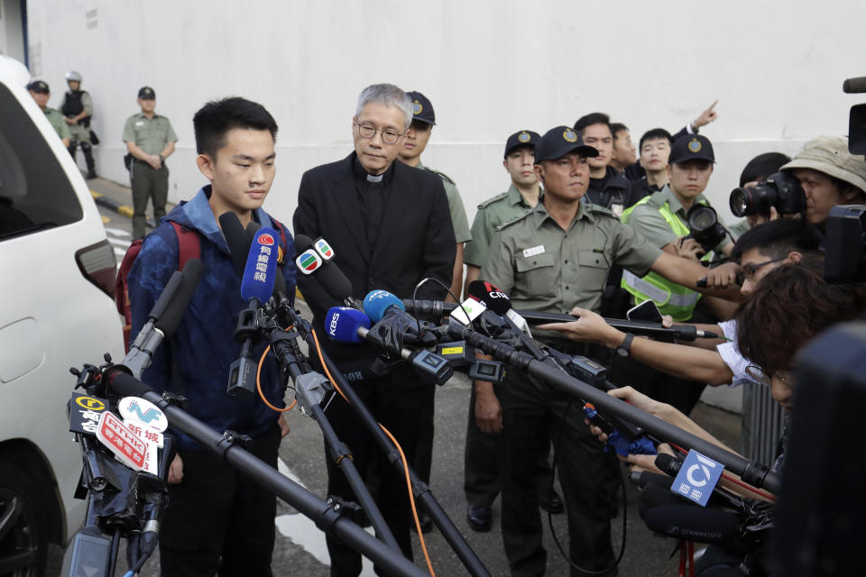 Chan Tong-kai, left, talks to the media as he is released from prison in Hong Kong Wednesday, Oct. 23, 2019. Chan, who's wanted for killing his girlfriend last year on the self-ruled island, had asked the Hong Kong government for help turning himself in to Taiwan after his sentence for money laundering offenses ends on Wednesday. (AP Photo/Mark Schiefelbein)