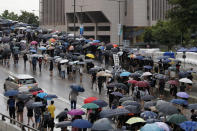 Protesters march in the rain in Hong Kong Sunday, Aug. 18, 2019. Heavy rain fell on tens of thousands of umbrella-toting protesters Sunday as they marched from a packed park and filled a major road in Hong Kong, where mass pro-democracy demonstrations have become a regular weekend activity this summer. (AP Photo/Vincent Thian)