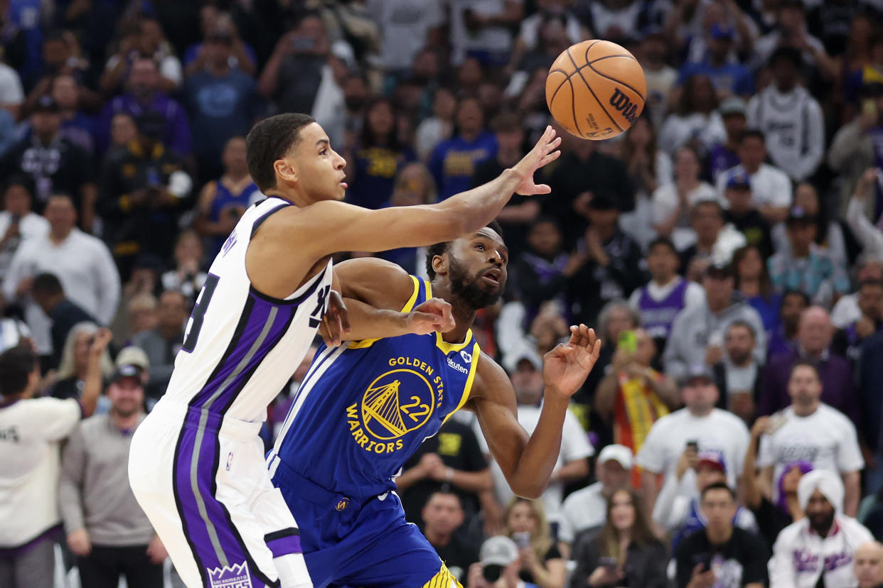 SACRAMENTO, CALIFORNIA - APRIL 16: Andrew Wiggins #22 of the Golden State Warriors and Keegan Murray #13 of the Sacramento Kings go for a loose ball in the first quarter during the Play-In Tournament at Golden 1 Center on April 16, 2024 in Sacramento, California.  NOTE TO USER: User expressly acknowledges and agrees that, by downloading and or using this photograph, User is consenting to the terms and conditions of the Getty Images License Agreement.  (Photo by Ezra Shaw/Getty Images)