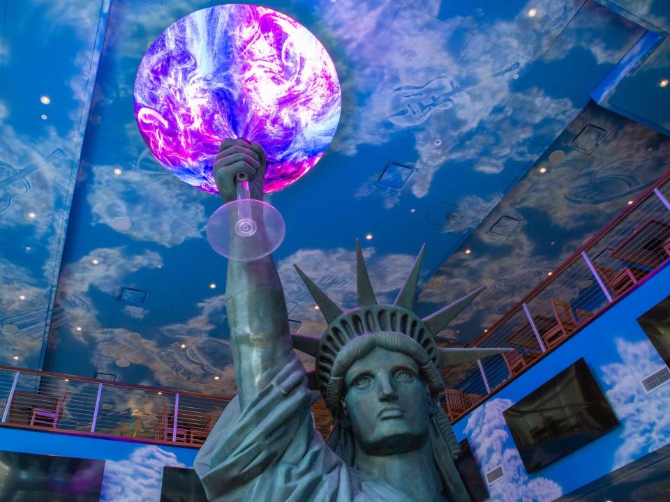 the Statue of Liberty holding a glowing glass