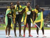 <p>Asafa Powell, Yohan Blake, Nickel Ashmeade and Usain Bolt of Jamaica celebrate after winning the gold. REUTERS/Alessandro Bianchi </p>