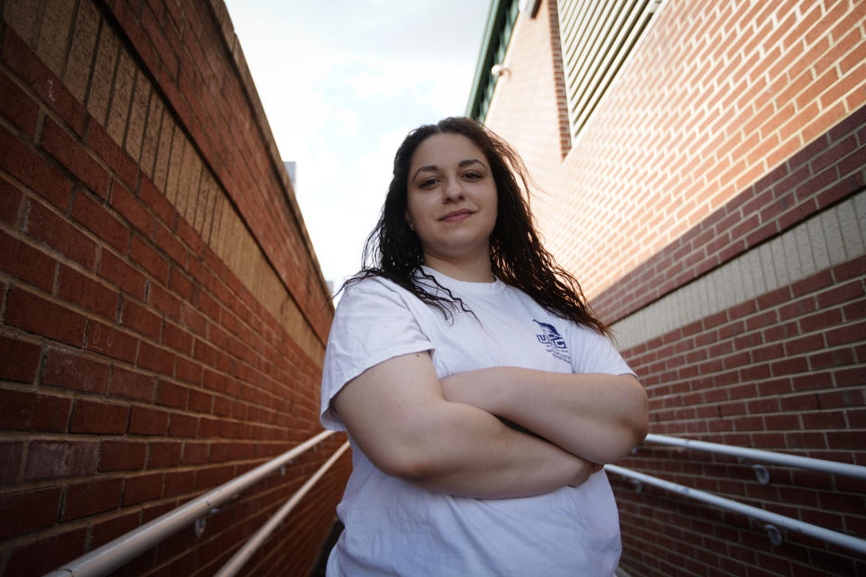 Laura Comino, a senior at the University of North Carolina at Greensboro poses for a picture on Tuesday, July 14, 2020, in Charlotte, N.C. College students are getting ready to return to school in August as the country deals with the coronavirus pandemic. More and more campuses are sparking frustration by releasing plans to keep students' housing payments, even if the campuses shut down again and go entirely online in the fall. (AP Photo/Chris Carlson)