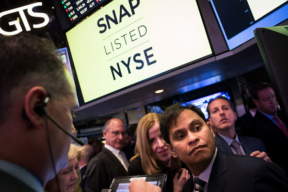 Imran Khan (R), chief strategy officer of Snap Inc., waits for shares to open for trading on the floor of the New York Stock Exchange (Photo by Drew Angerer/Getty Images)