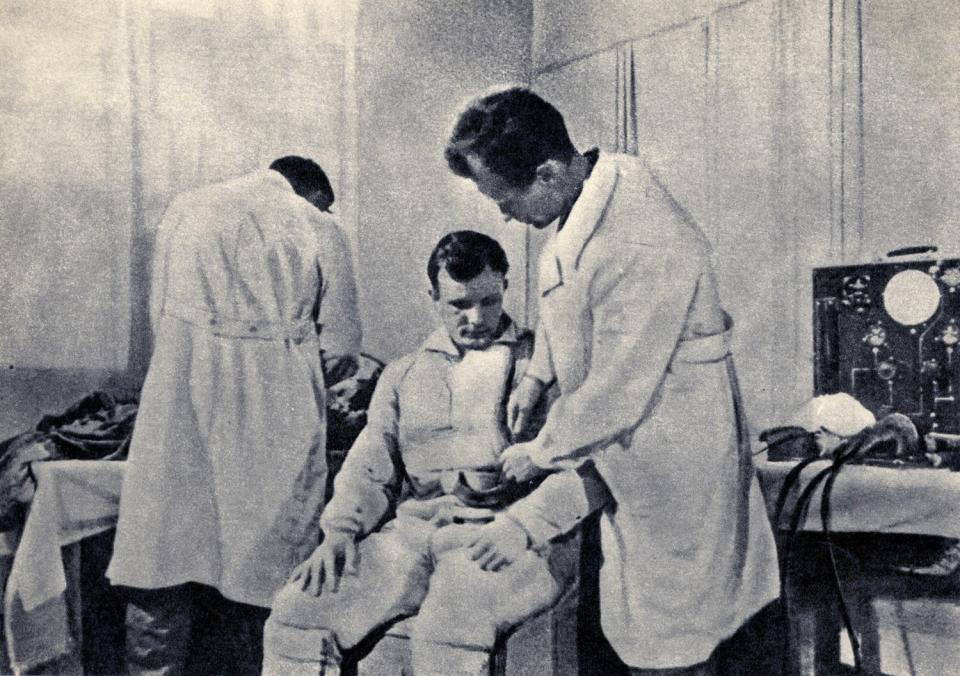 Drawn from the film <i>First Trip to the Stars,</i> Gagarin is shown being examined before his flight