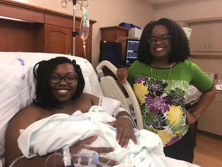 Dr. Nicole Arthur (R), visits Tariyana Wiggins, a high school teacher, shortly after the birth of Troy O’Brien Williams in the hospital room at the North Baldwin Infirmary, a 70-bed hospital in rural Bay Minette, Alabama, U.S. on June 22, 2017. REUTERS/Jilian Mincer