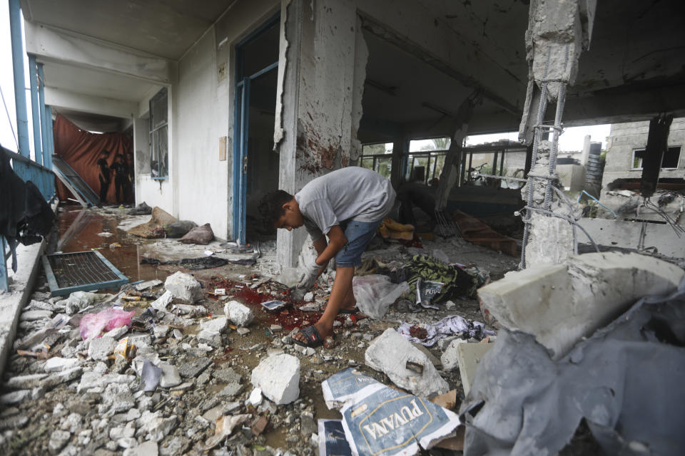 A Palestinian looks at the aftermath of the Israeli strike on a U.N.-run school that killed dozens of people in the Nusseirat refugee camp in the Gaza Strip, Thursday, June 6, 2024. The Israeli military said that Hamas militants were operating from within the school. (AP Photo/Ismael Abu Dayyah)