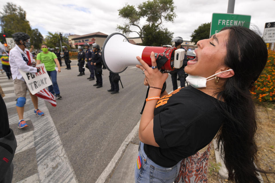 Demonstration co-organizer Sanah Niaci uses a megaphone during a protest, Saturday, June 6, 2020, in Simi Valley, Calif. over the death of George Floyd. Protests continue throughout the country over the death of Floyd, a black man who died after being restrained by Minneapolis police officers on May 25 (AP Photo/Mark J. Terrill)