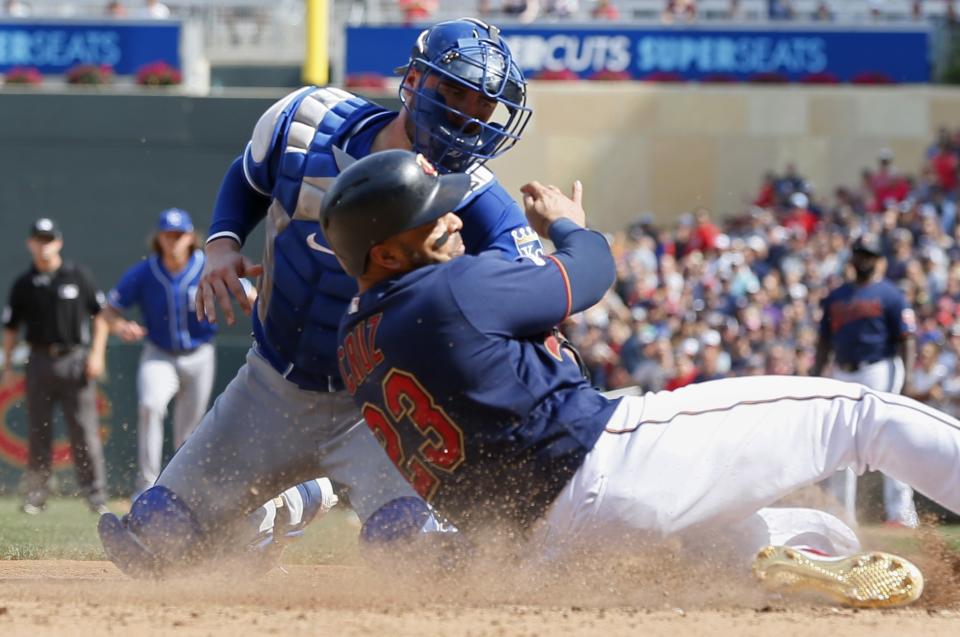 Minnesota Twins' Nelson Cruz, right, is tagged out at the plate by Kansas City Royals catcher Cam Gallagher as he tried to score from third on a single by Eddie Rosario in the eighth inning of a baseball game Sunday, Aug. 4, 2019, in Minneapolis. The Twins won 3-0. (AP Photo/Jim Mone)