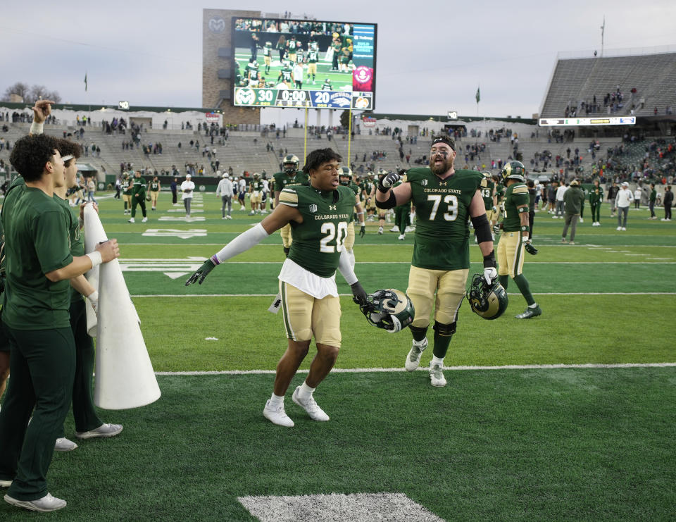 Colorado State defensive back Jaylen Gardner (20) and offensive lineman Oliver Jervis (73) celebrate after defeating Nevada in an NCAA college football game Saturday, Nov. 18, 2023, in Fort Collins, Colo. (AP Photo/David Zalubowski)