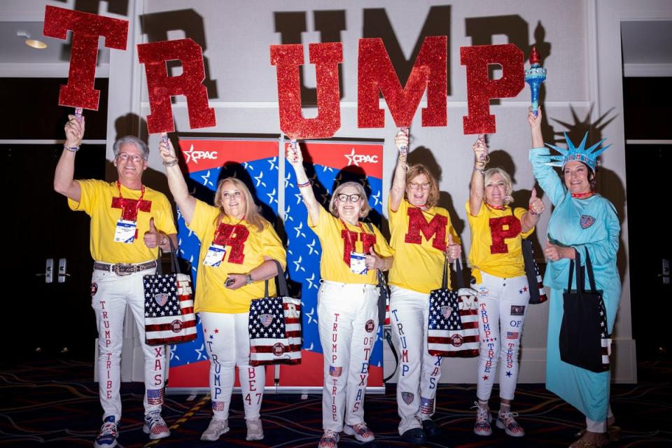 A group of Trump supporters hold up signs at the Conservative Political Action Conference (CPAC) annual meeting in National Harbor, Maryland, U.S., February 22, 2024 (REUTERS)