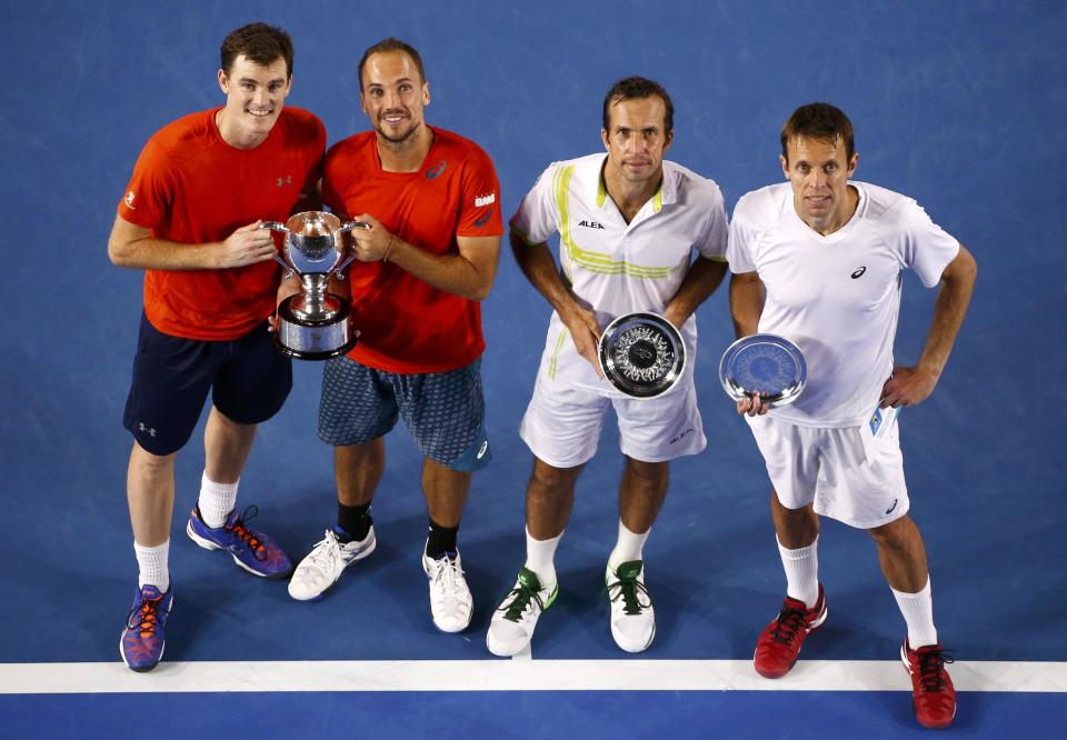 Britain's Jamie Murray (L-R) and Brazil's Bruno Soares celebrate with the men's doubles trophy after winning their doubles final match against Czech Republic's Radek Stepanek and Canada's Daniel Nestor at the Australian Open tennis tournament at Melbourne Park, Australia, January 31, 2016. REUTERS/Jason Reed