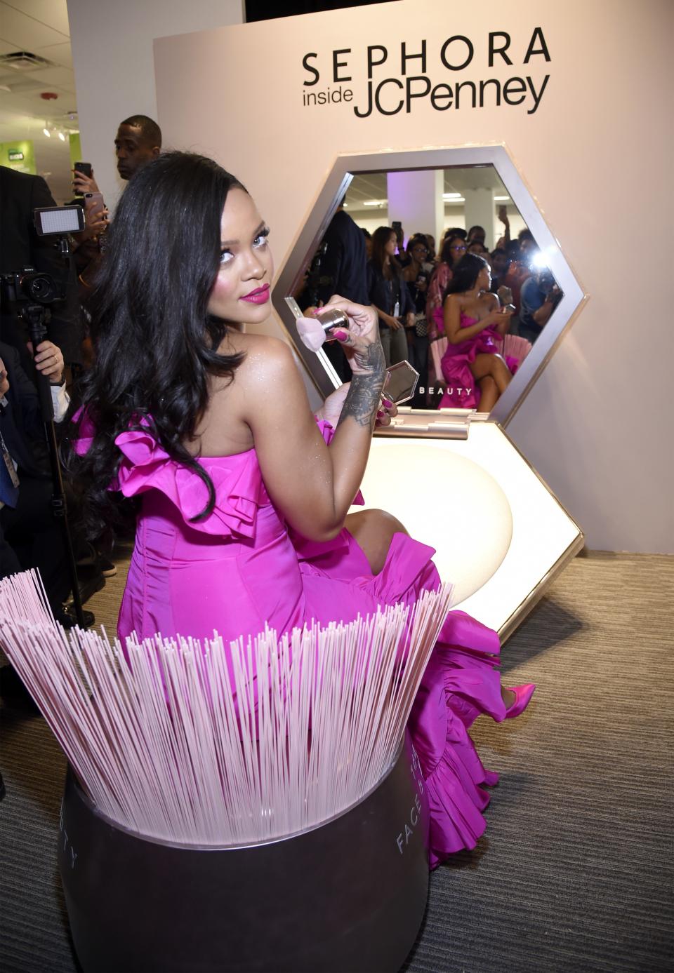 Rihanna wore an eye-popping fuchsia gown to the birthday bash of her cosmetics company, Fenty Beauty, on Friday night.