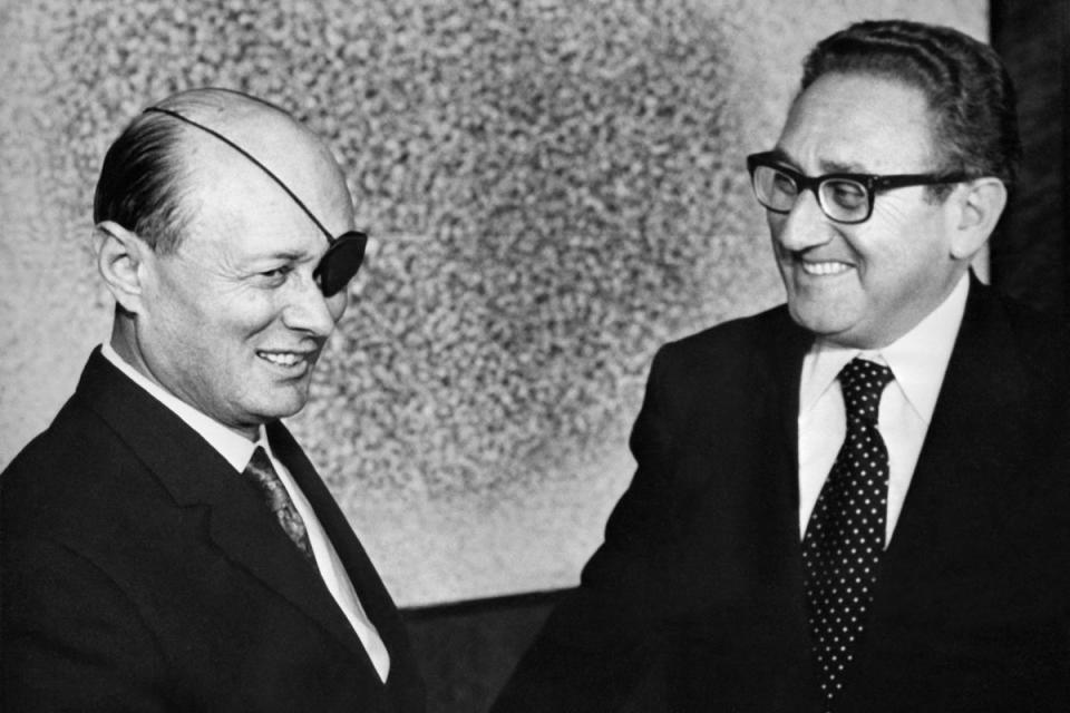 US Secretary of State Henry Kissinger, right, meets with Israel’s Defence Minister Moshe Dayan in Tel Aviv on 8 January, 1974 (AFP via Getty Images)