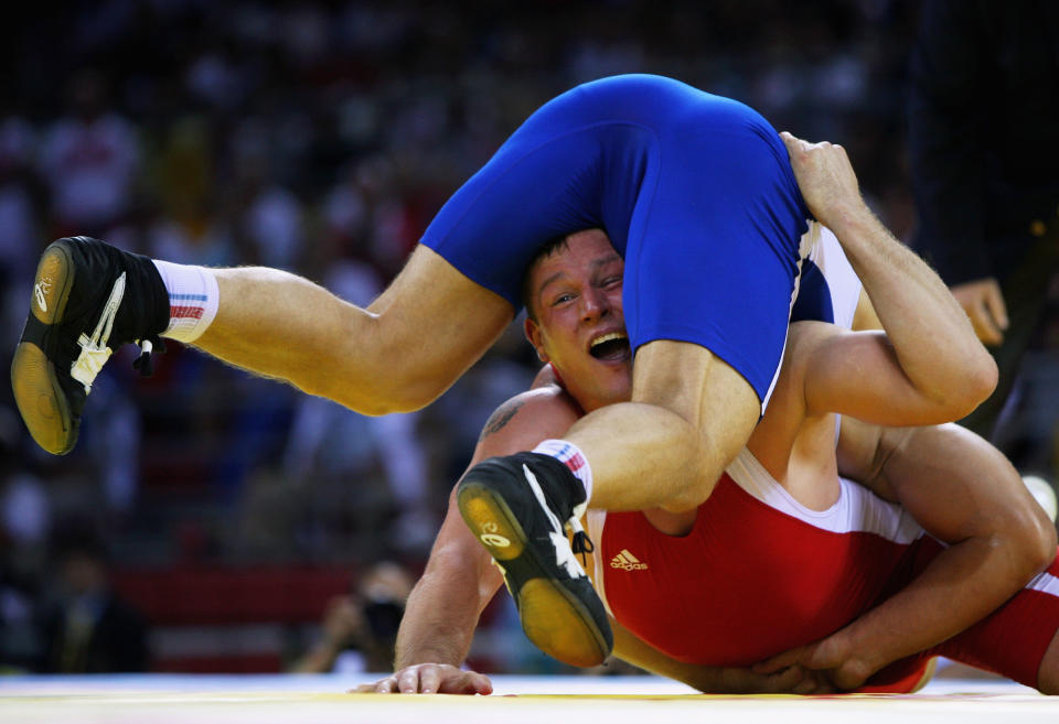 Aslanbek Khustov (blue) of Russia and Mirko Englich (red) of Germany compete in the Men's Greco-Roman 96kg gold medal bout at the China Agriculture University Gymnasium during Day 6 of the Beijing 2008 Olympic Games on August 14, 2008 in Beijing, China. (Ezra Shaw/Getty Images)