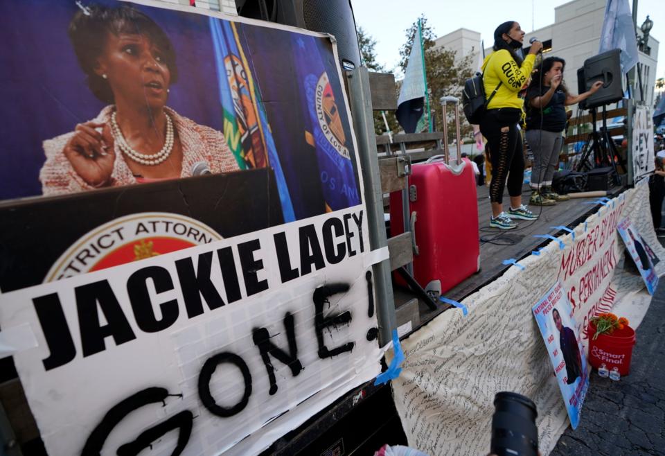 Protesters gather outside the gated Hall of Justice to protest Los Angeles District Attorney Jackie Lacey in downtown Los Angeles, Wednesday, Nov. 4, 2020.  Dovarganes)