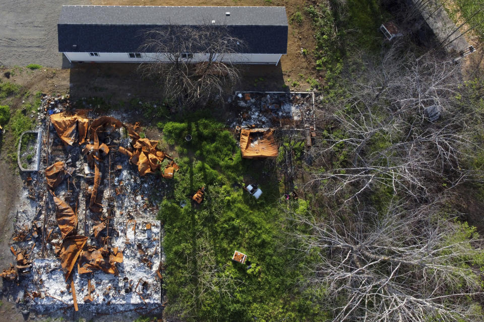 In this aerial photo a new home sits next to a home that burned down during the Echo Mountain fire in Otis, Ore., on Thursday, May. 13, 2020. The small Oregon coast town is still recovering from the devastating fire that destroyed 293 homes. (AP Photo/Craig Mitchelldyer)