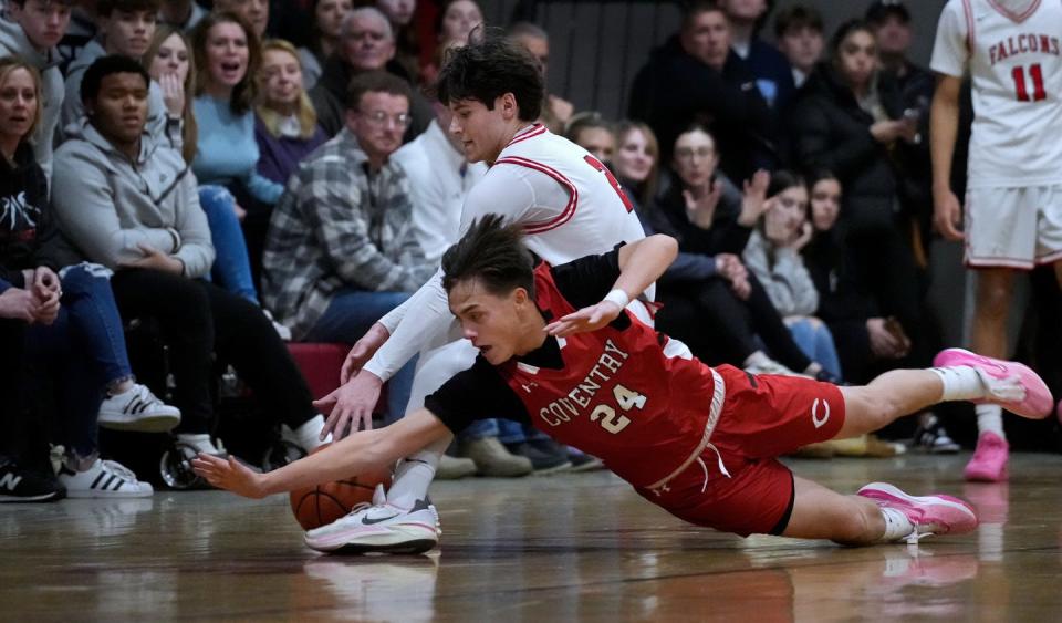 Coventry's Samuel Fuentes dives in front of Cranston West's Ryan Zarrella for a loose ball in the first half of their playoff game on Thursday.