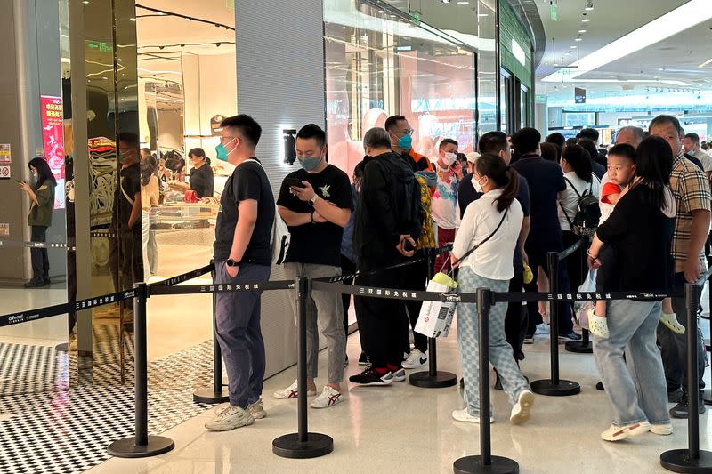 FILE PHOTO: People visit the Sanya International Duty-Free shopping complex in Sanya