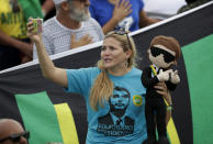 A supporter of Brazil's new President Jair Bolsonaro holds a Bolsonaro doll, during his inauguration in Brasilia, Brazil, Tuesday, Jan. 1, 2019. (AP Photo/Silvia Izquierdo)