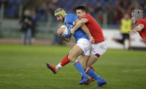 Italy's Angelo Esposito, left, challenges for the ball Wales' Owen Watkin during the Six Nations rugby union international between Italy and Wales, at Rome's Olympic Stadium, Saturday, Feb. 9, 2019. (AP Photo/Andrew Medichini)