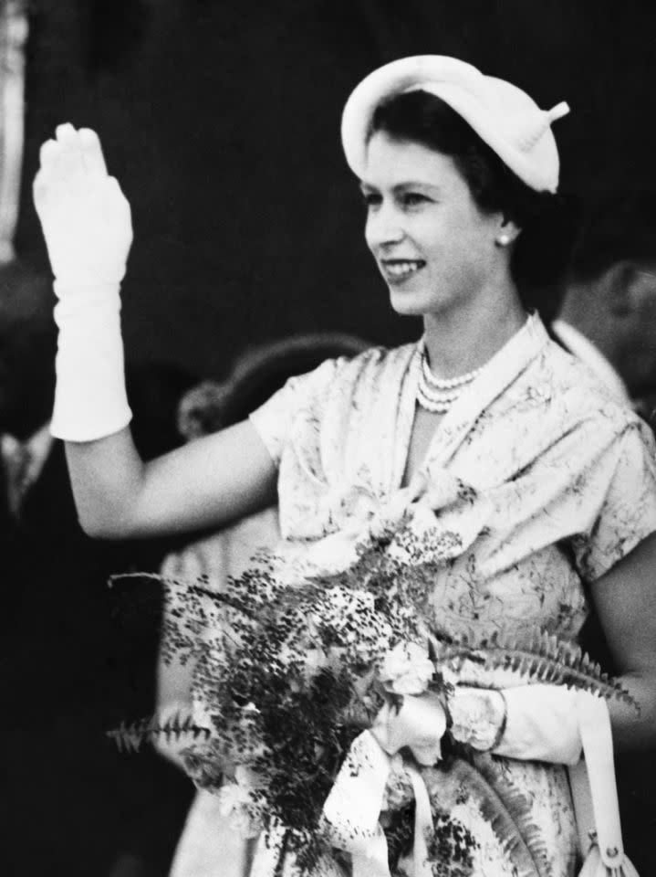 <p>Queen Elizabeth II waves at the crowds in New Zealand on her first royal tour. (PA) </p>