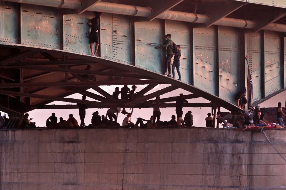 Protesters stage a sit-in under a bridge that leads to the Green Zone where many government offices and embassies are located, during ongoing anti-government protests in Baghdad, Iraq, Tuesday, Nov. 5, 2019. (AP Photo/Hadi Mizban)