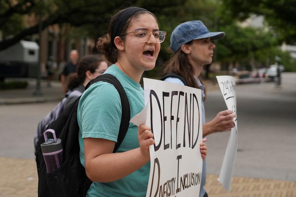 Ashley Awad participates in a protest to defend diversity, equity and inclusion at the University of Texas in April 2023. The Legislature has banned DEI offices and programs at public universities, leading to dozens of layoffs at UT.