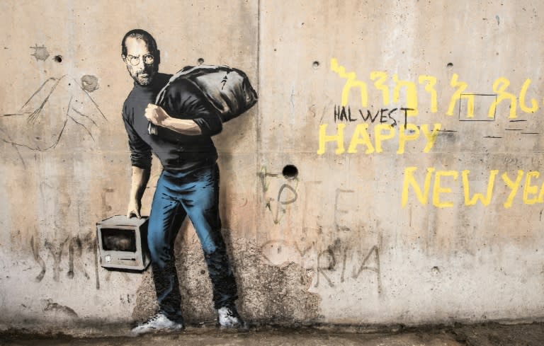 Banksy often produces art in charged political settings, such as this 2015 mural in the Calais "jungle" of migrants seeking to leave France for Britain, entitled "The Son of a Migrant from Syria" and depicting Apple co-founder Steve Jobs, who was of Syrian descent