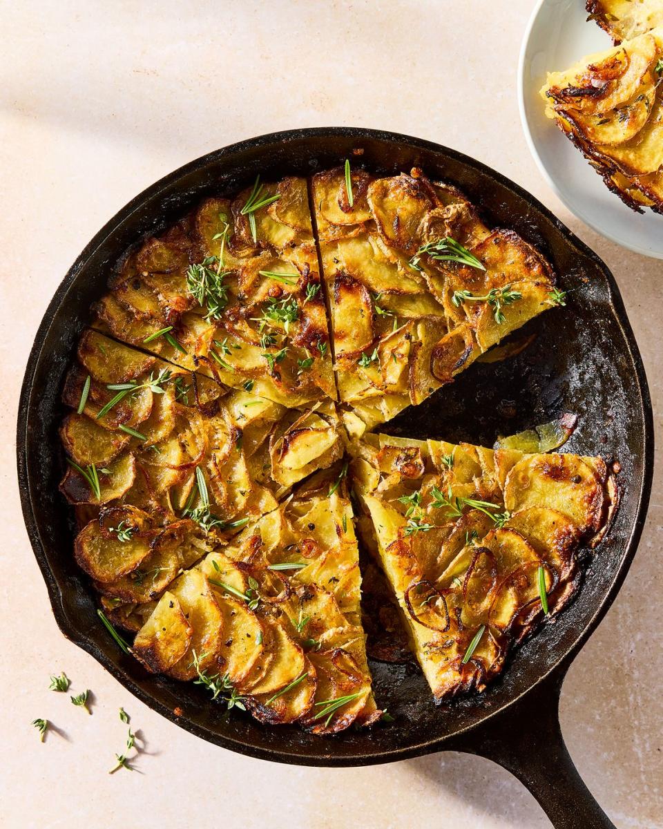 galette in a pan layered with thinly sliced potatoes