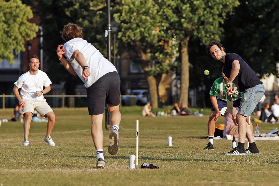 A group of boys play cricket on Clapham Common, London, on Bank Holiday Monday after the introduction of measures to bring the country out of lockdown due to the coronavirus pandemic.