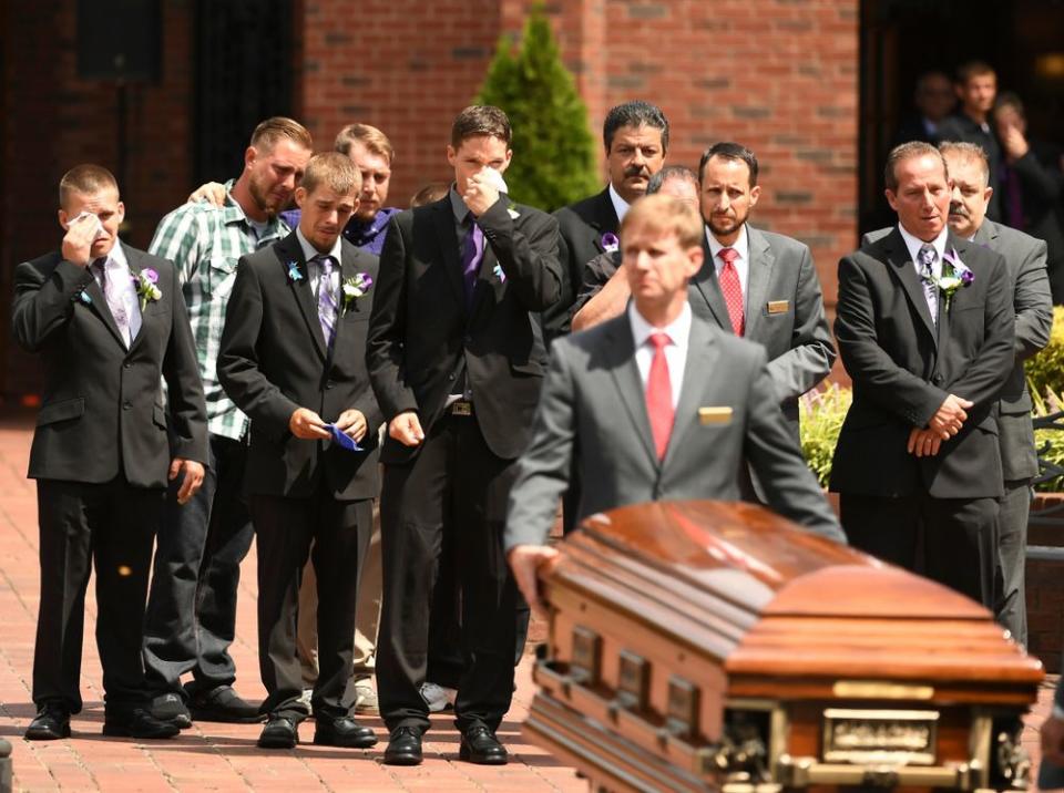 The casket of one of the girls is brought out of the church during the funeral for Shanann, Bella and Celeste Watts.