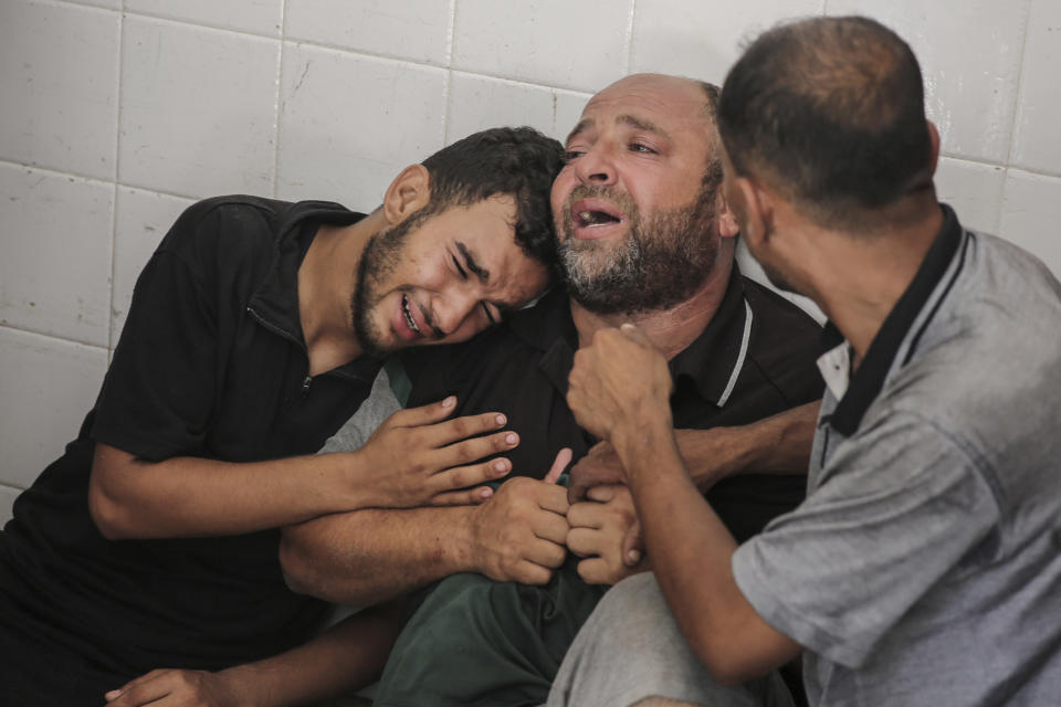 The father of Mohammad al-Habil weeps with his relatives after his son was killed with his uncle, Abdul Muti al-Habil, while they were fishing in the sea when Israeli gunboats opened fire on them in Deir al Balah, Gaza Strip, Friday, June 14, 2024. The bodies of the two fishermen were brought to Al-Aqsa Martyrs Hospital after they were shot by Israel's navy, the hospital officials said. (AP Photo/Mohammad Hajjar)