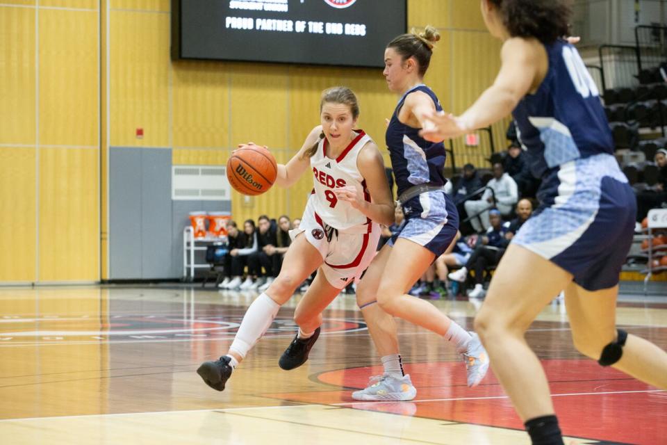 Veinot, in the white, seen playing against the St. Francis Xavier University team on Feb. 9. She had a career point total of 1,695.