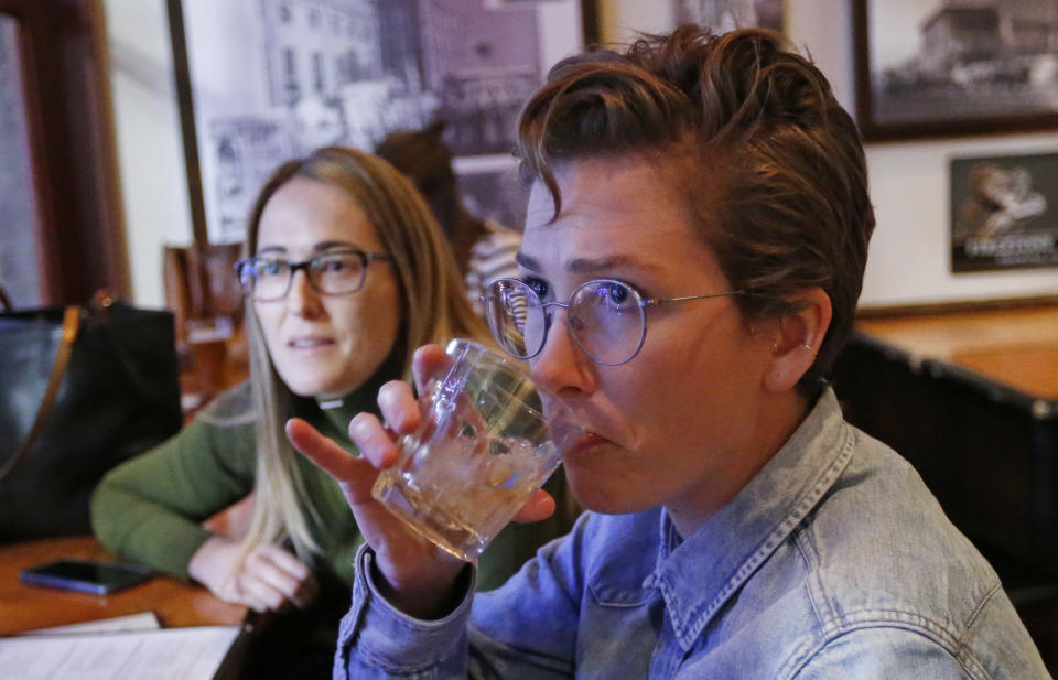 In this Dec. 20, 2018, photo, Maude Romney, 29, right, drinks at the Beer Hive Pub, in Salt Lake City. The United States' lowest DUI threshold takes effect this weekend in Utah. Stopping for a whiskey after work with her sister at the upscale pub Beerhive, Maude Romney, 29, said she'll likely only go to places she can walk to from her home downtown. "I'm paranoid about it already," she said. (AP Photo/Rick Bowmer)