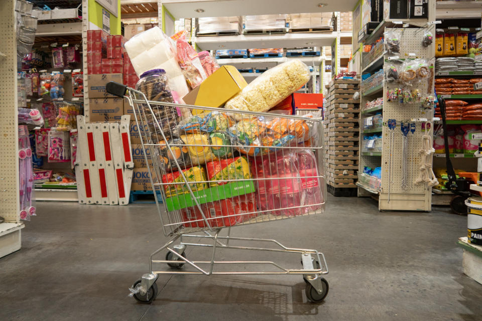 An abandoned shopping cart full of items