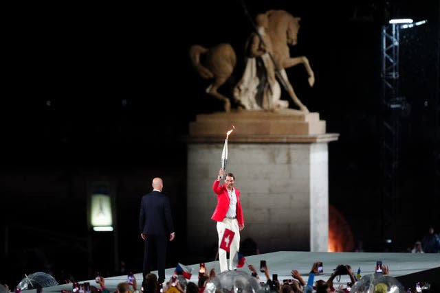 Rafael Nadal carries the Olympic torch at the opening ceremony 