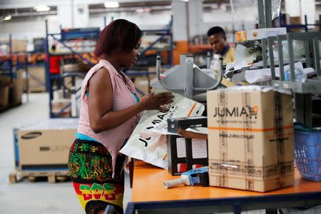 A woman works at the packaging unit at a warehouse for an online store, Jumia in Ikeja district, in Nigeria's commercial capital Lagos June 10, 2016.REUTERS/Akintunde Akinleye