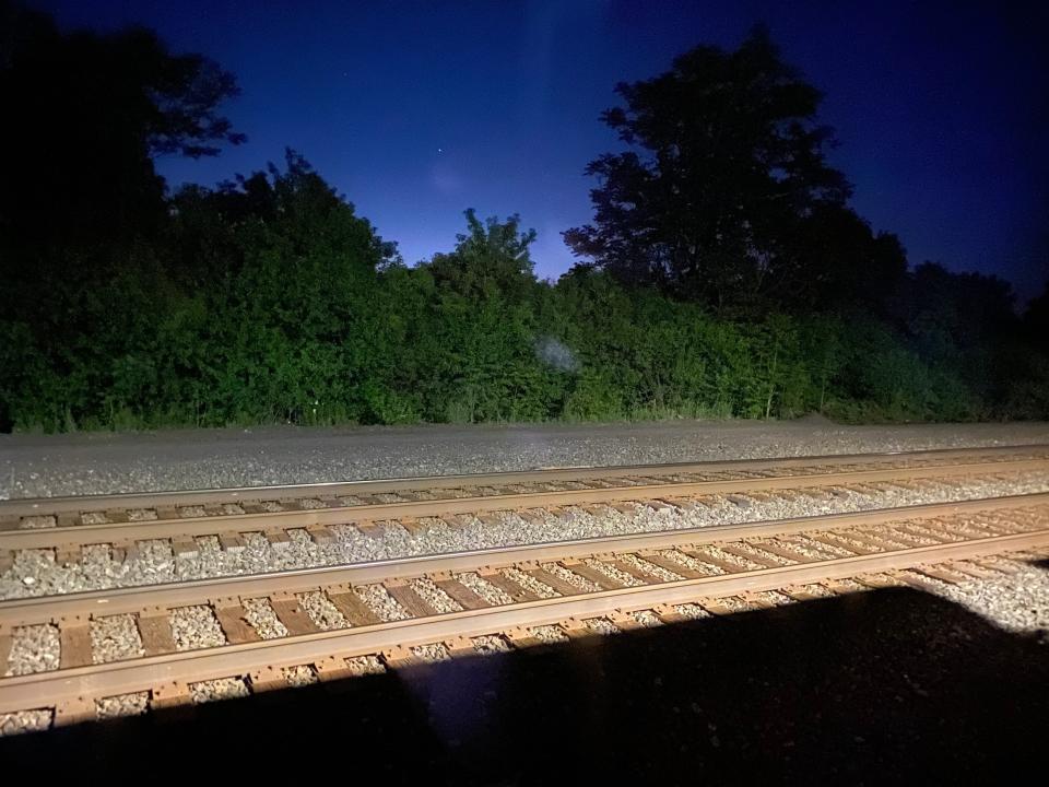 The dark railroad tracks aboard an amtrak train