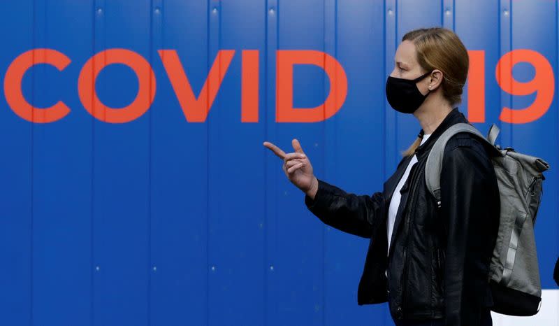 A woman waits to get tested for the coronavirus disease in Prague