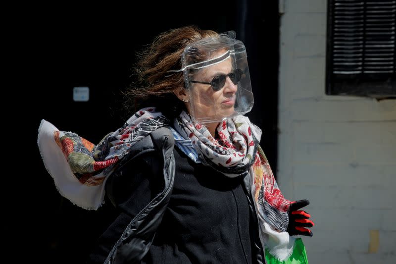 A woman wears a plastic food container for protection during the outbreak of the coronavirus disease (COVID19) in Brooklyn, New York