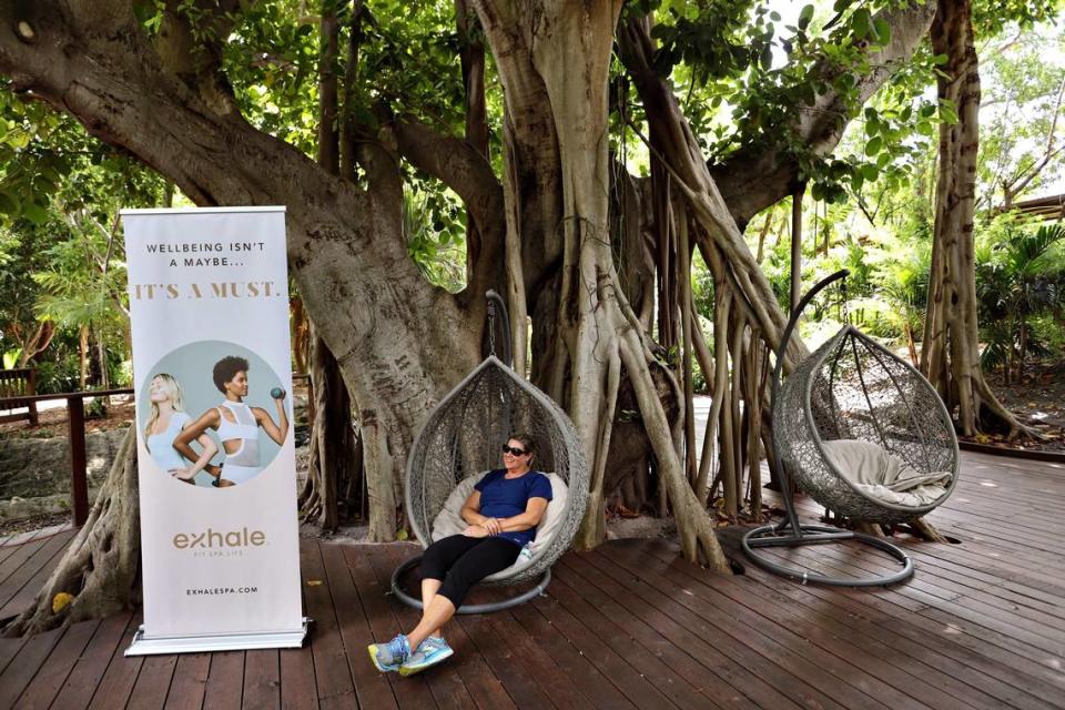 Marine animal trainer, Allison Collins, 46, takes in the view as she waits for the start of a yoga workout at Jungle Island.