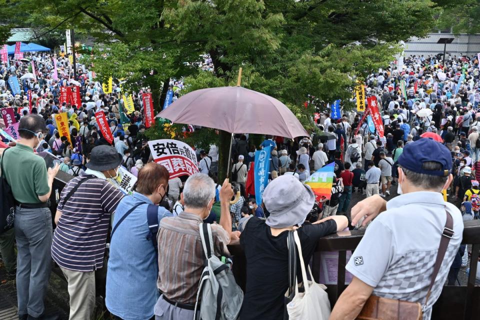 People gather to listen to speeches as anti-war, anti-nuclear and protesters against the government’s funding for the funeral of late Japanese prime minister Shinzo Abe (AFP via Getty Images)