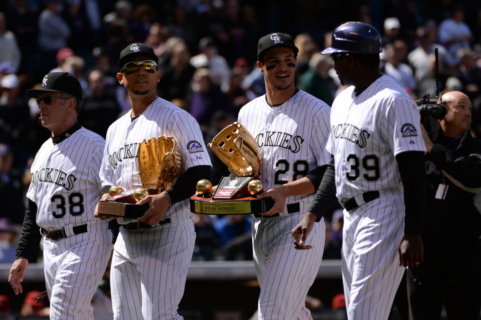 (From left) Coach Rene Lachemann, Carlos Gonzalez, Nolan Arenado and coach Stu Cole walk off the field after opening ceremonies. The Colorado Rockies hosted the Arizona Diamondbacks in the Rockies season home opener at Coors Field in Denver, Colorado Friday, April 4, 2014. (Photo by Hyoung Chang/The Denver Post via Getty Images)