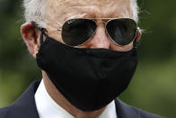 FILE - In this May 25, 2020, file photo Democratic presidential candidate, former Vice President Joe Biden wears a face mask to protect against the spread of coronavirus as he and Jill Biden depart after placing a wreath at the Delaware Memorial Bridge Veterans Memorial Park in New Castle, Del. Biden has won the last few delegates he needed to clinch the Democratic nomination for president. (AP Photo/Patrick Semansky, File)