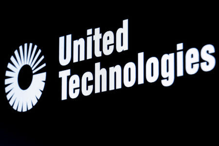 FILE PHOTO - The ticker symbol for United Technologies is displayed at the post where it is traded on the floor of the New York Stock Exchange (NYSE) in New York, U.S. on February 23, 2016. REUTERS/Brendan McDermid/File Photo