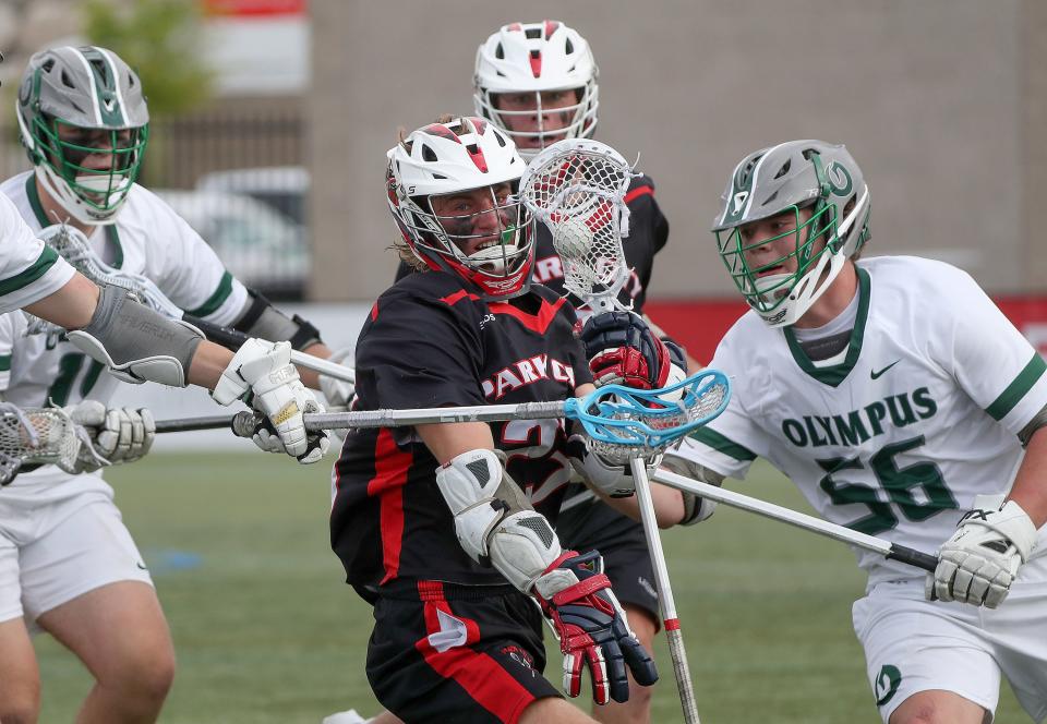 Park City’s Chase Beyer pushes through a crowd of Olympus players, including Tommy Barrus on the right, during the 5A boys lacrosse state championship game at Zions Bank Stadium in Herriman on Friday, May 27, 2022. Park City won 10-9. | Kristin Murphy, Deseret News
