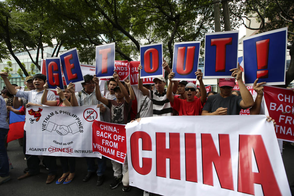 FILE - In this May 16, 2014, file photo, Vietnamese expatriates and Filipinos protest the recent moves by China to construct an oil rig near the Vietnamese-claimed Paracels off the contested Spratlys group of islands and shoals in the South China Sea. In comments last week, Vietnamese President Nguyen Phu Trong said it was time to take stock after three months of tensions with Beijing over Vietnamese-controlled Vanguard Reef that China also claims, according to Hong Kong’s South China Morning Post news. (AP Photo/Bullit Marquez, File)