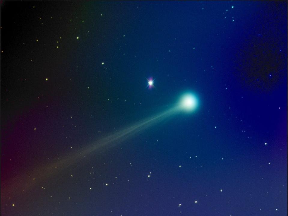 A green comet that takes about 50,000 years to complete its orbit