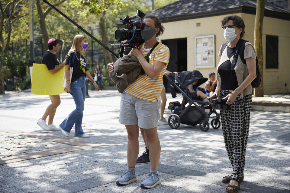 This image released by Focus Features shows director Julie Cohen, right, on the set of the documentary "Every Body." (Focus Features via AP)