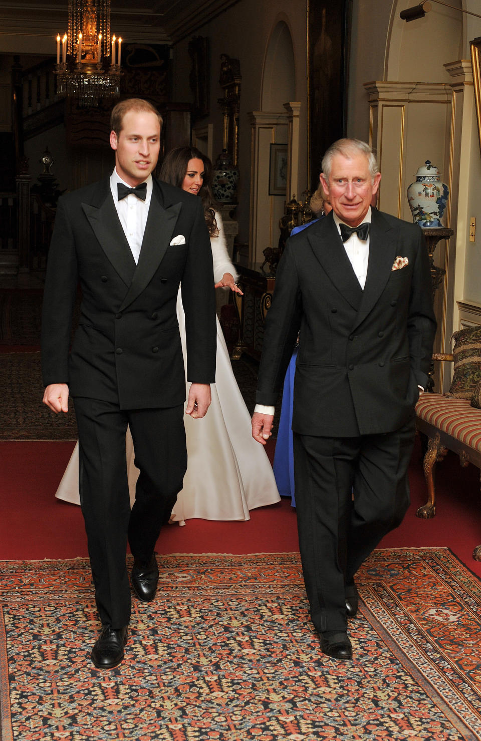 The Prince of Wales walks with his son Prince William followed by the Duchess of Cambridge and the Duchess of Cornwall, as they leave Clarence House to travel to Buckingham Palace for a dinner and party, this evening.  